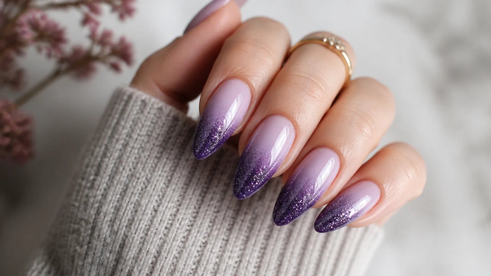 Light purple almond nails with a deeper amethyst glitter gradient