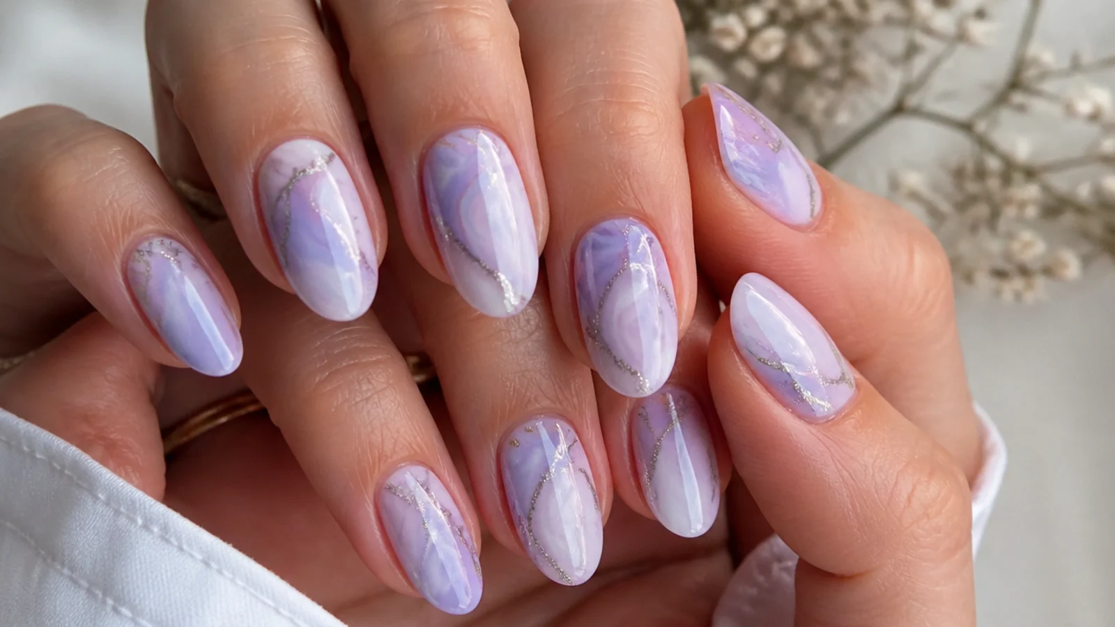 Light purple and white marble nails with silver glitter veins