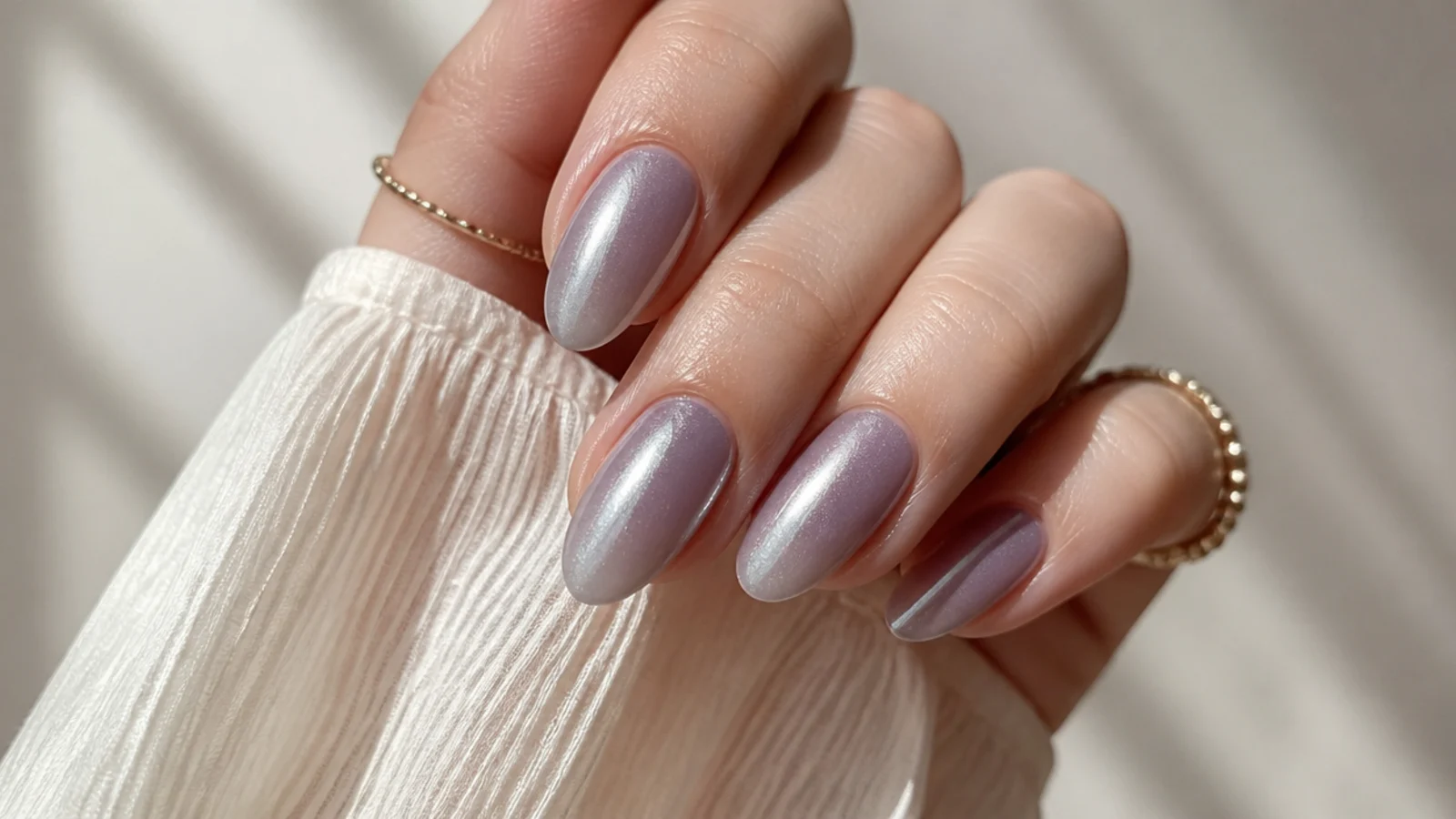 Muted grayed lilac nails with a glazed pearl finish