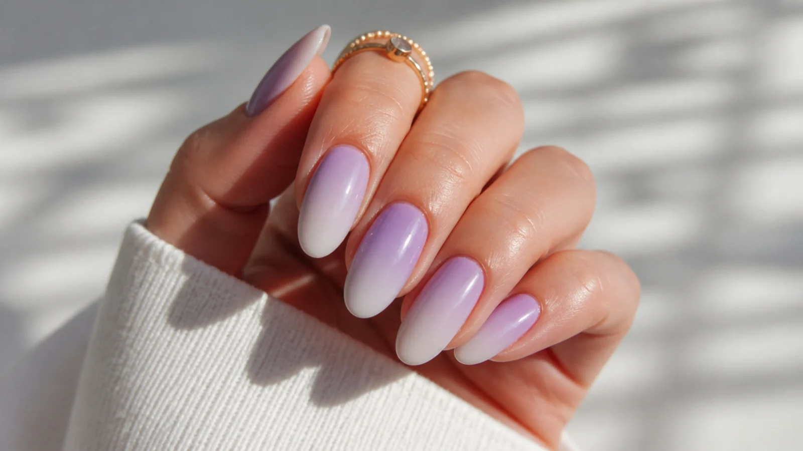 Light purple to white ombre nails with a soft blended fade