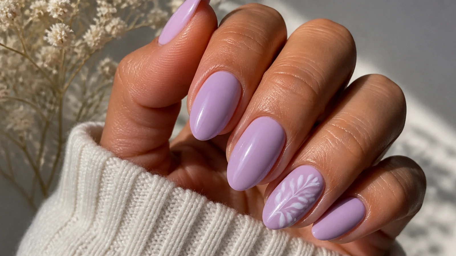 Warm pink-toned light purple nails on tan skin