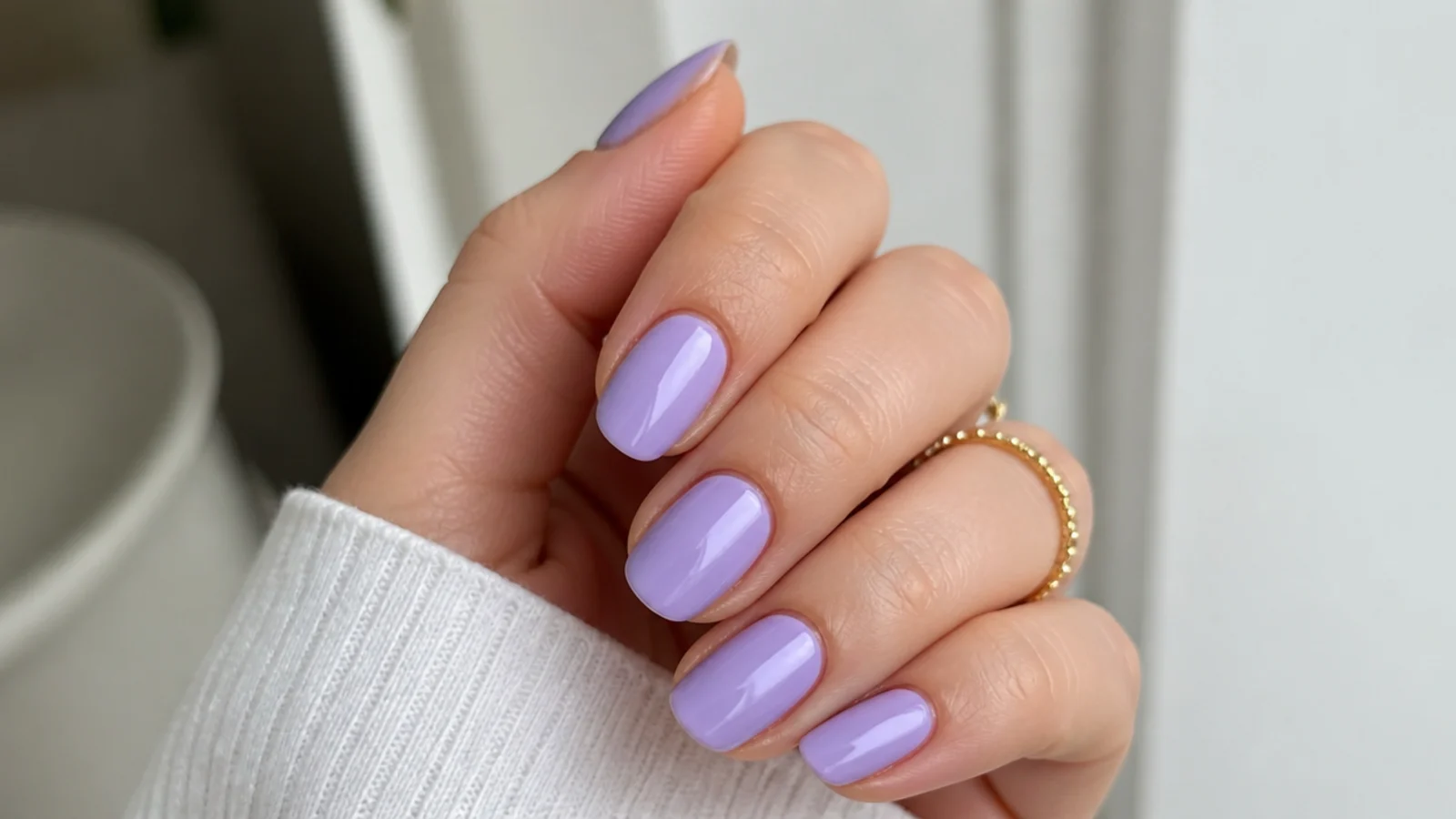 Cool-toned true lilac nails on fair skin with a soft gloss