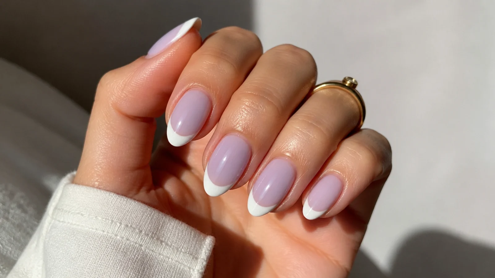 Milky white French tips with a soft lavender wash over the nail