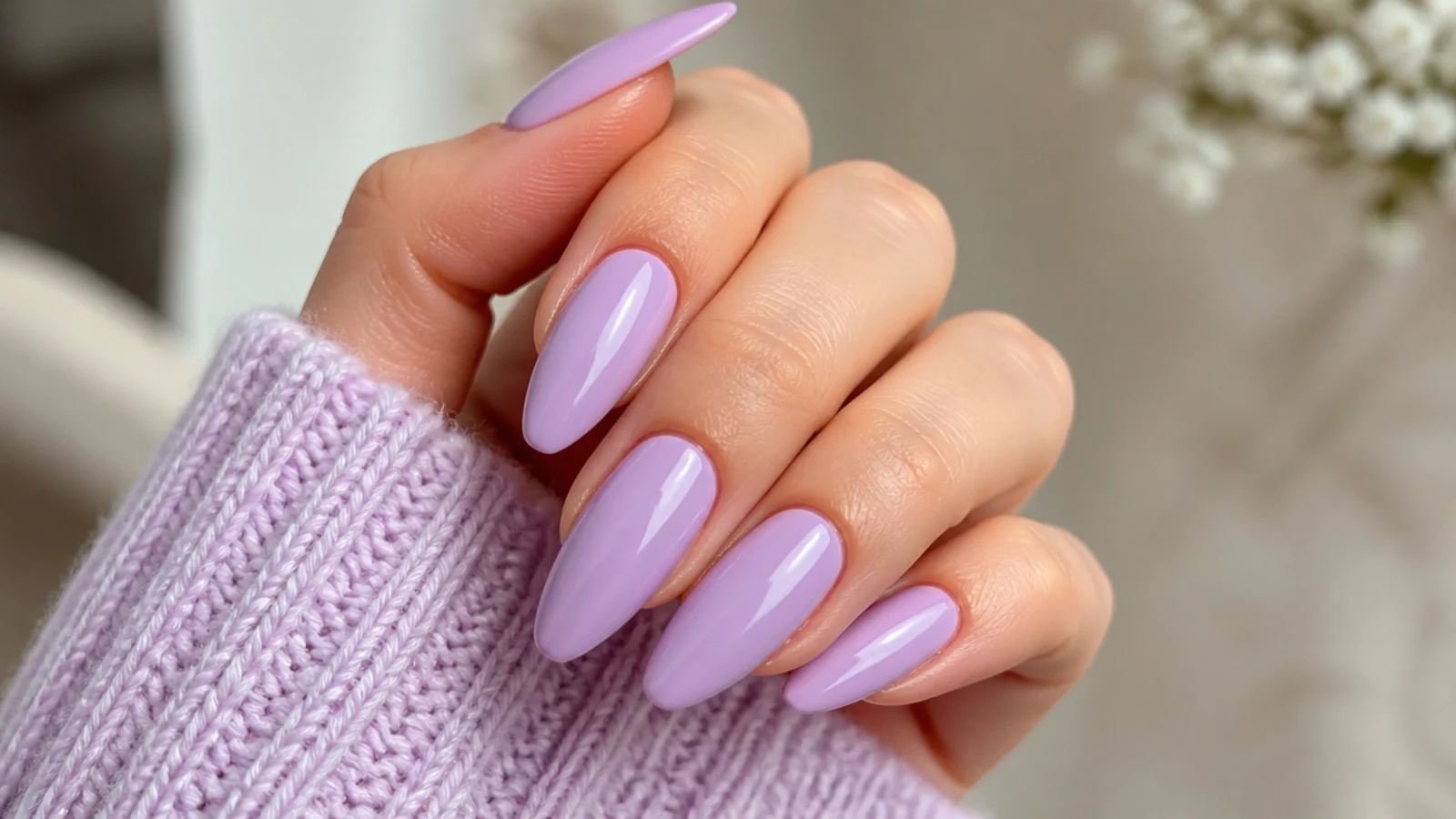 Long light purple almond nails with a high-gloss lilac finish