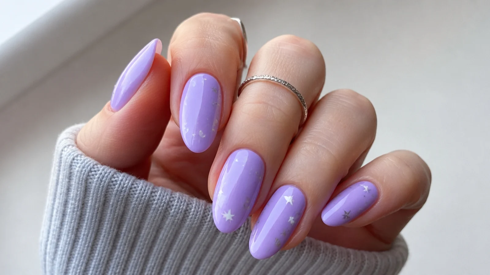 Light purple nails with small silver and white star details
