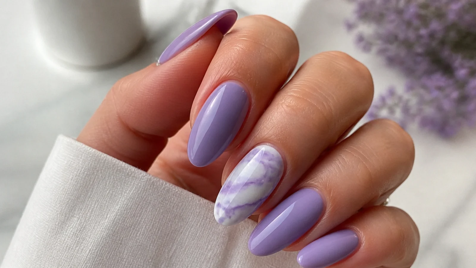 Light purple nails with a soft purple and white marble accent nail