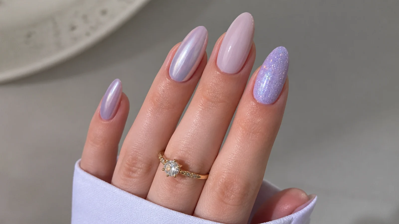 Light purple nails shown in chrome, milky, glitter and almond finishes