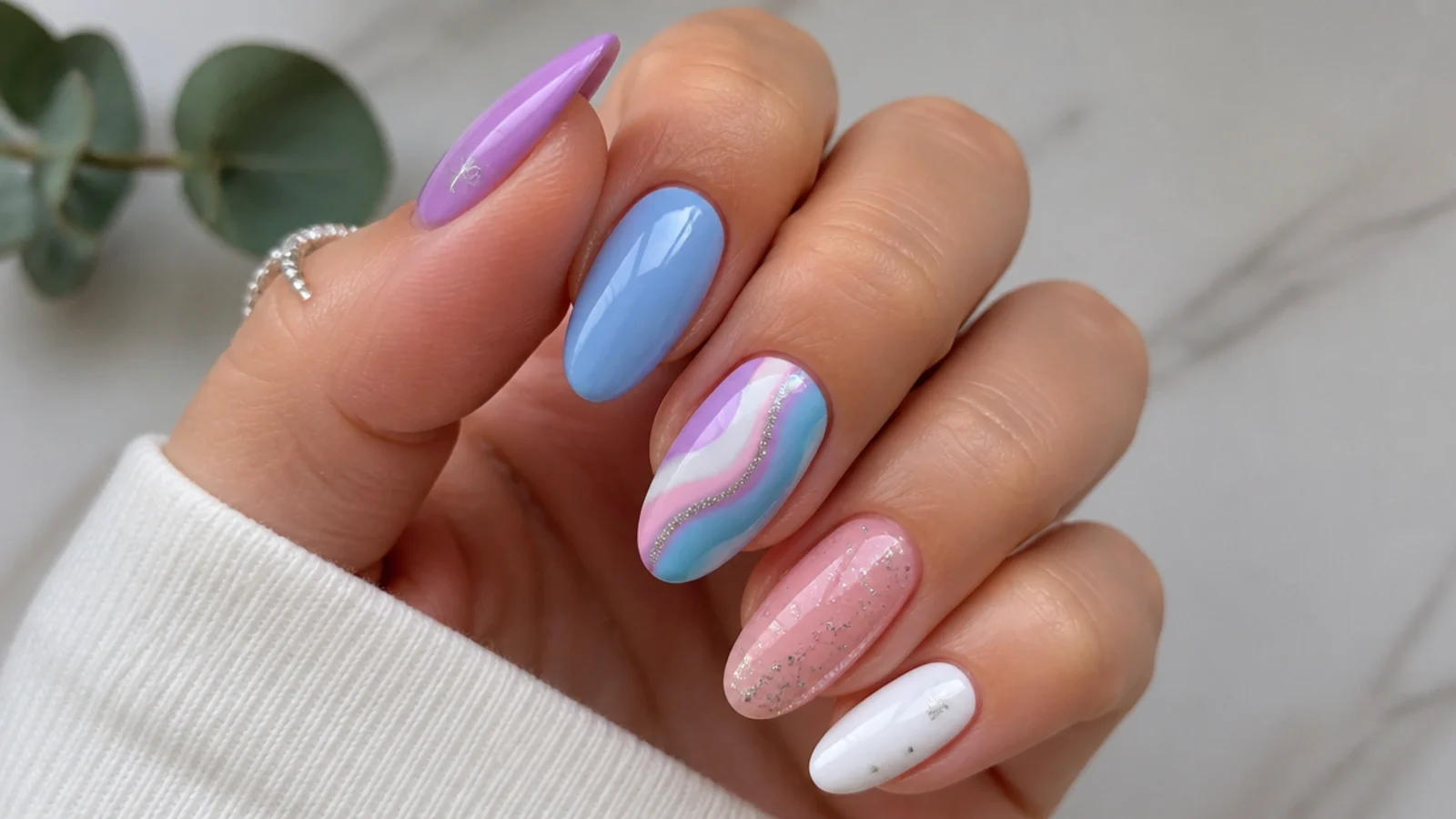 Light purple nails paired with blue, pink, white and silver accents