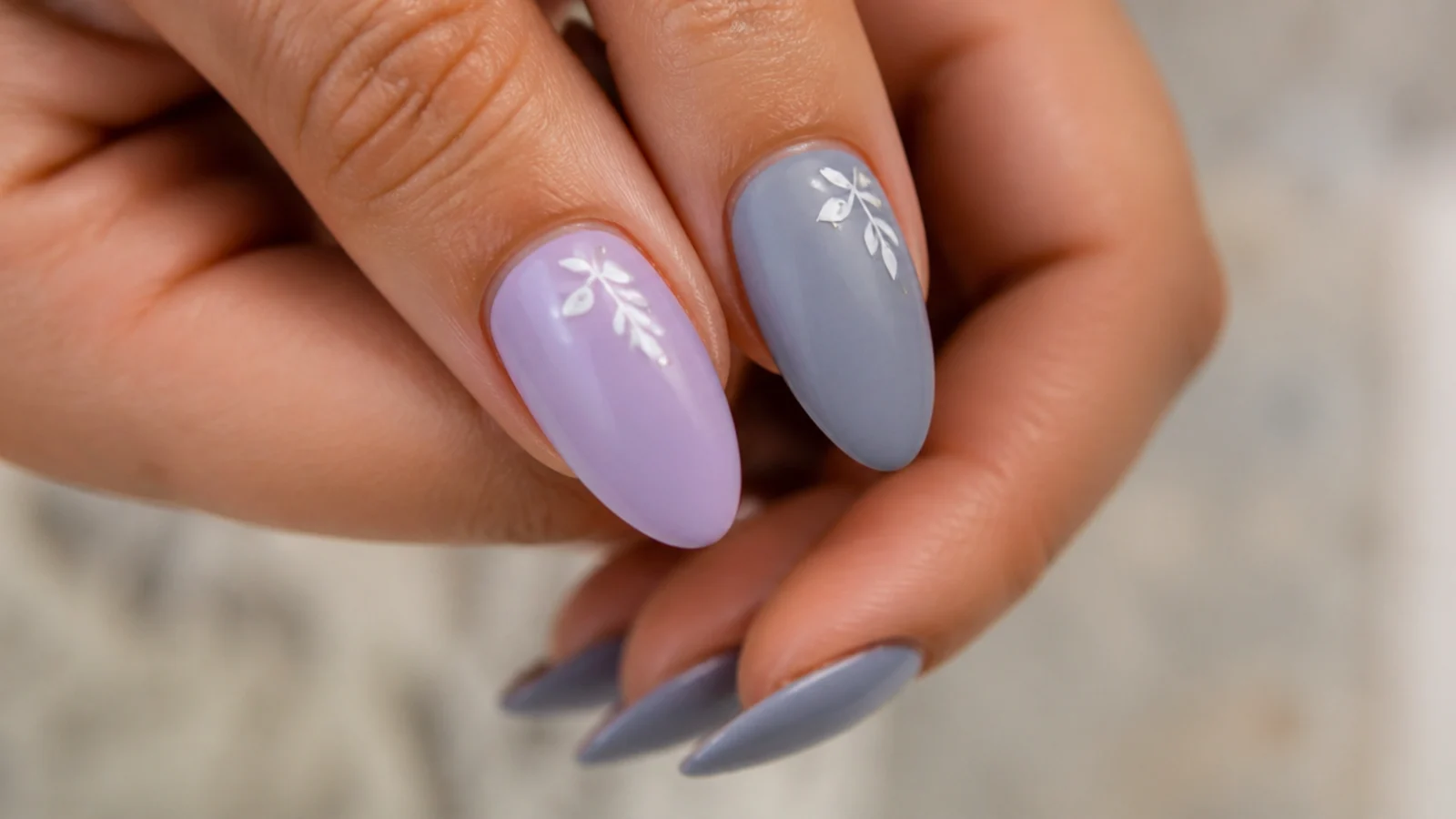 A soft lilac nail beside a gray-blue lavender nail for comparison