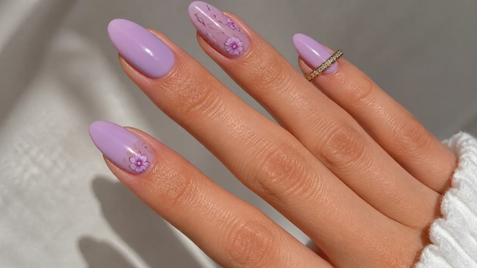 Warm pink-toned light purple nails on tan skin