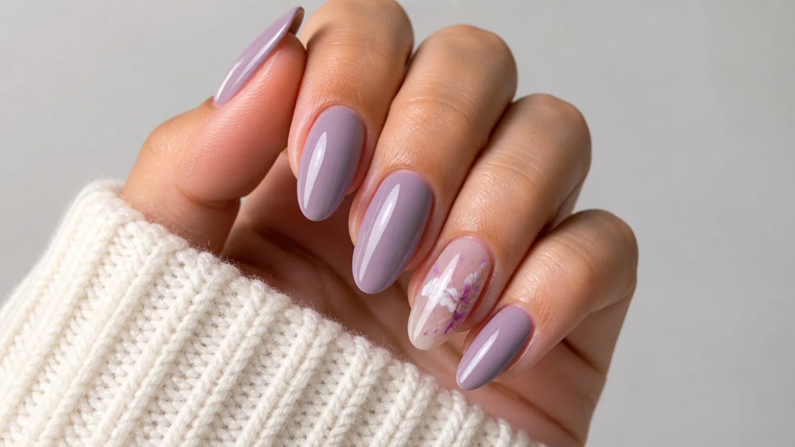 Muted grayed light purple nails in a dusty lilac tone