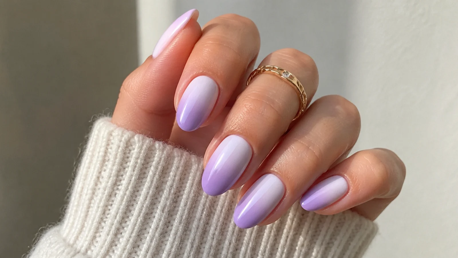 Light purple ombre nails fading from white to soft lilac