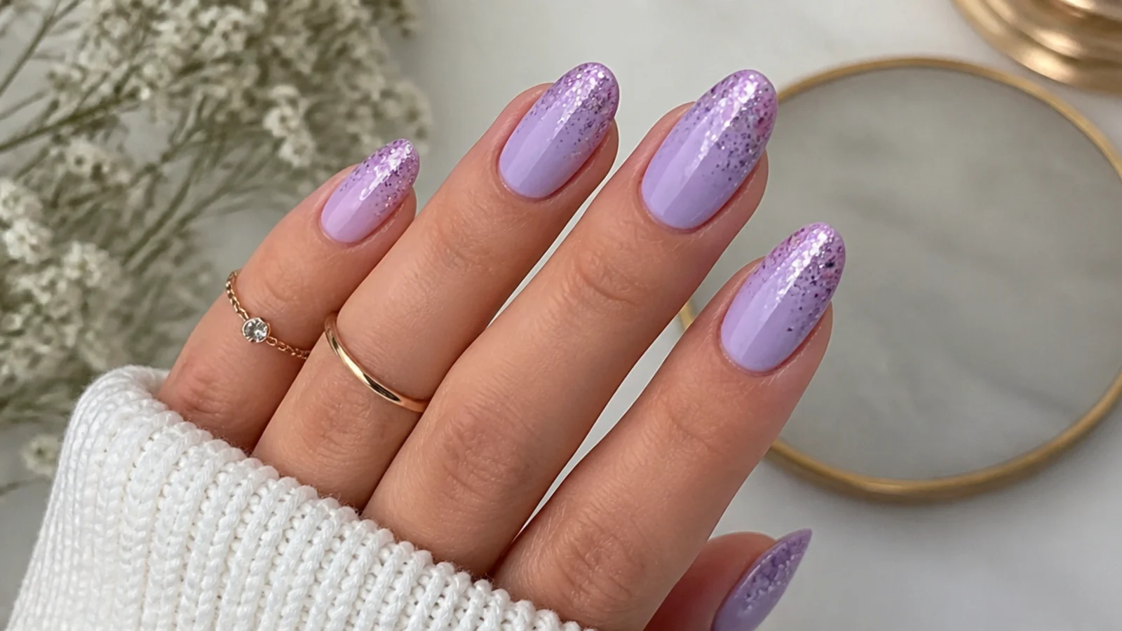 Light purple nails with a glitter gradient toward the tips