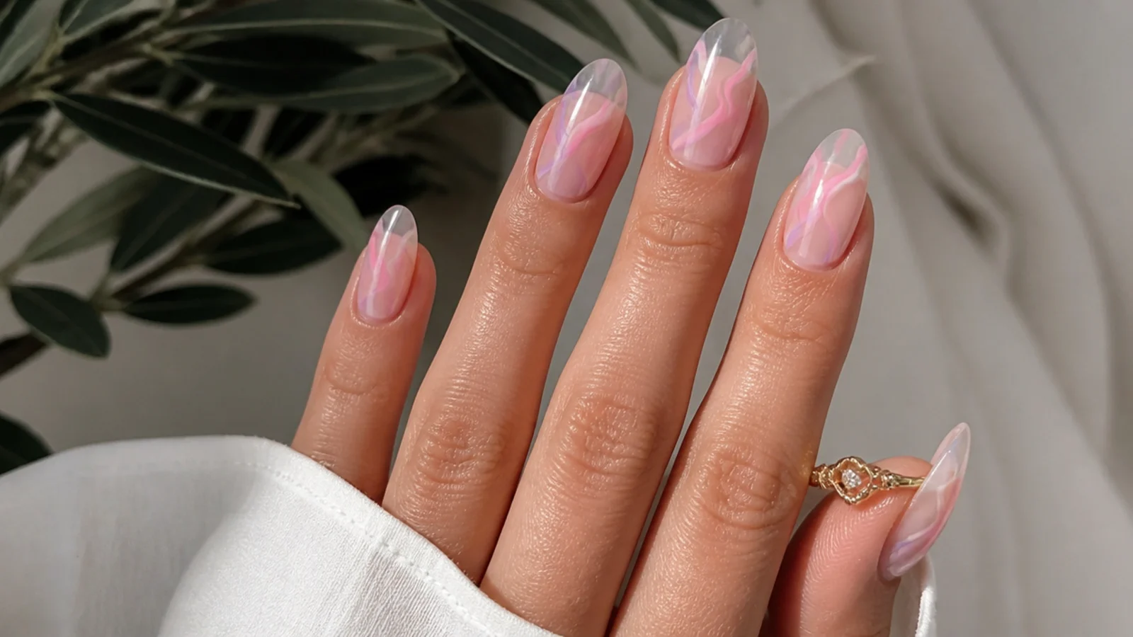 Swirled soft pink and light purple nails on a milky base
