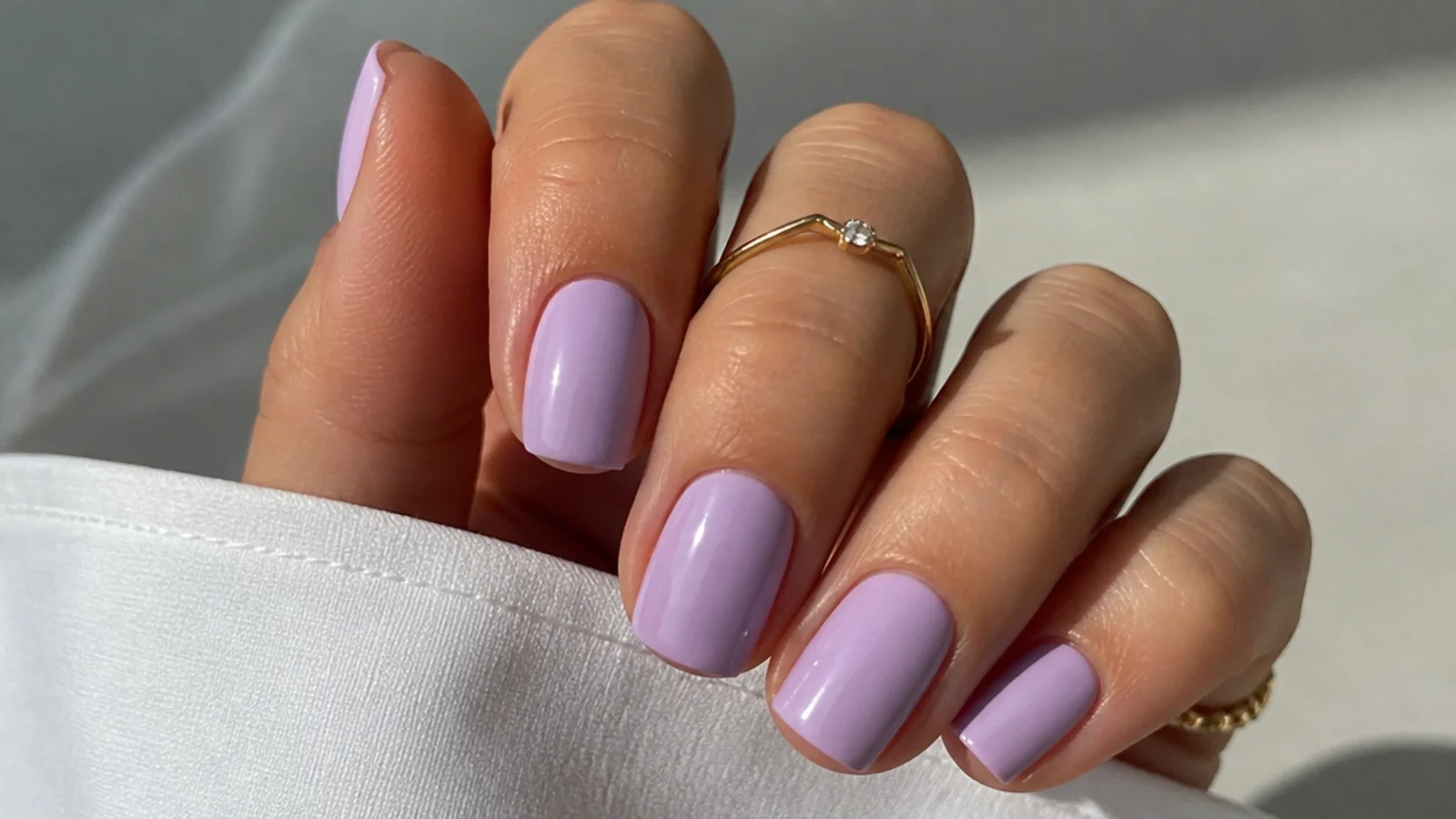 Short squoval light purple nails in a soft opaque lilac