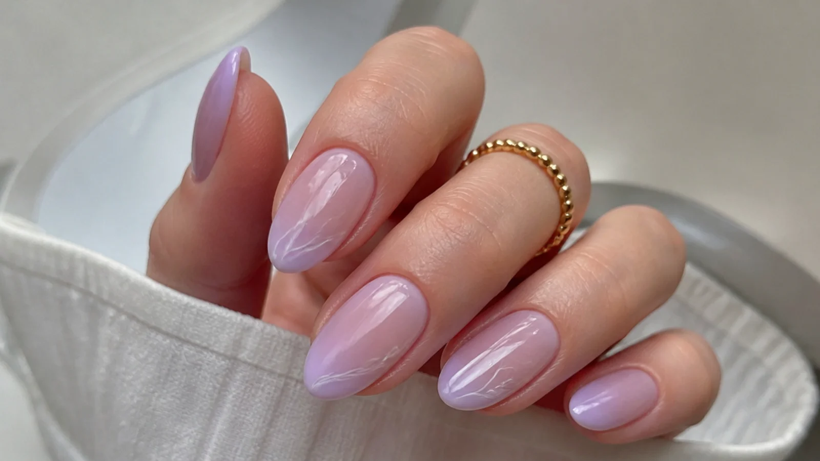 A milky light purple gel built in sheer coats over a nude base