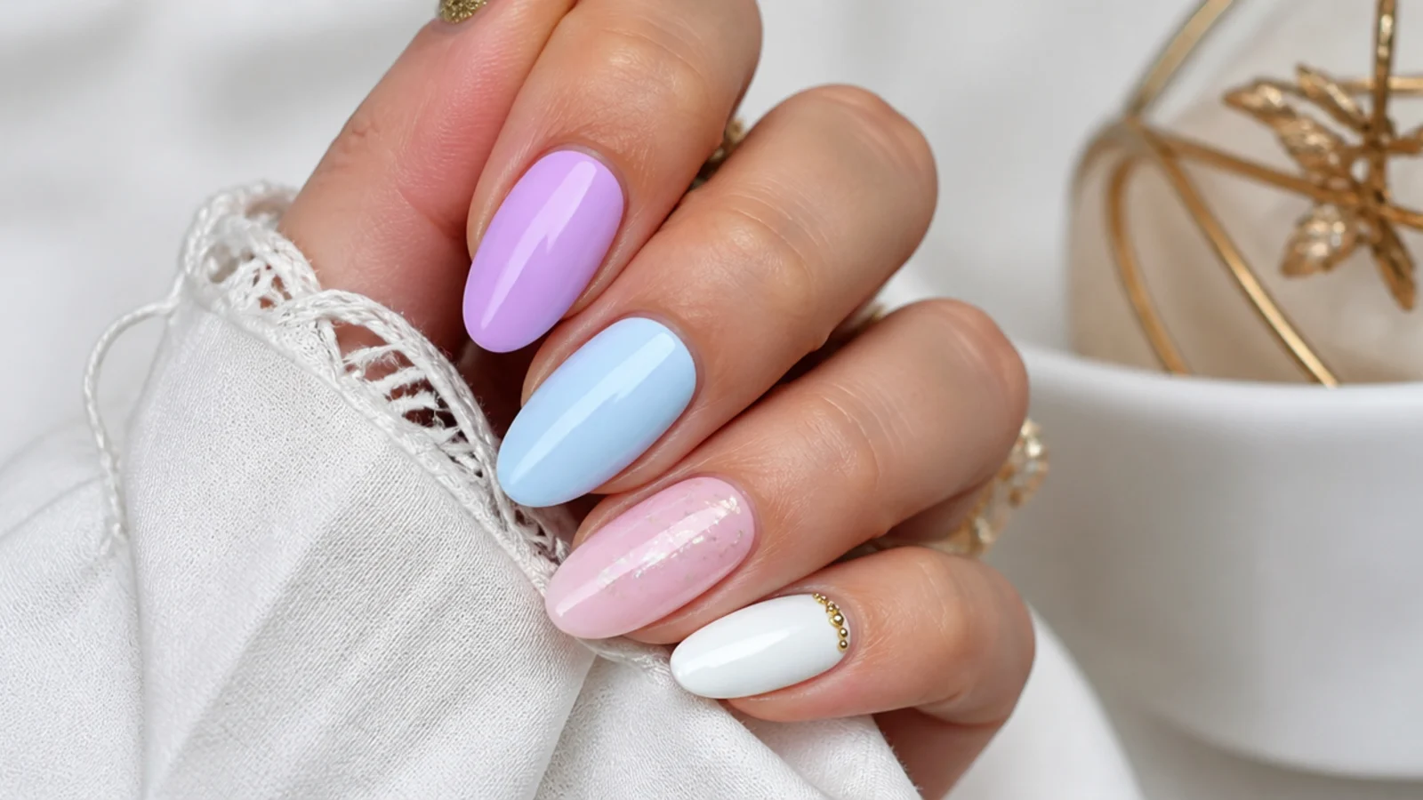 Light purple nails shown beside light blue, soft pink, white, silver and gold accents