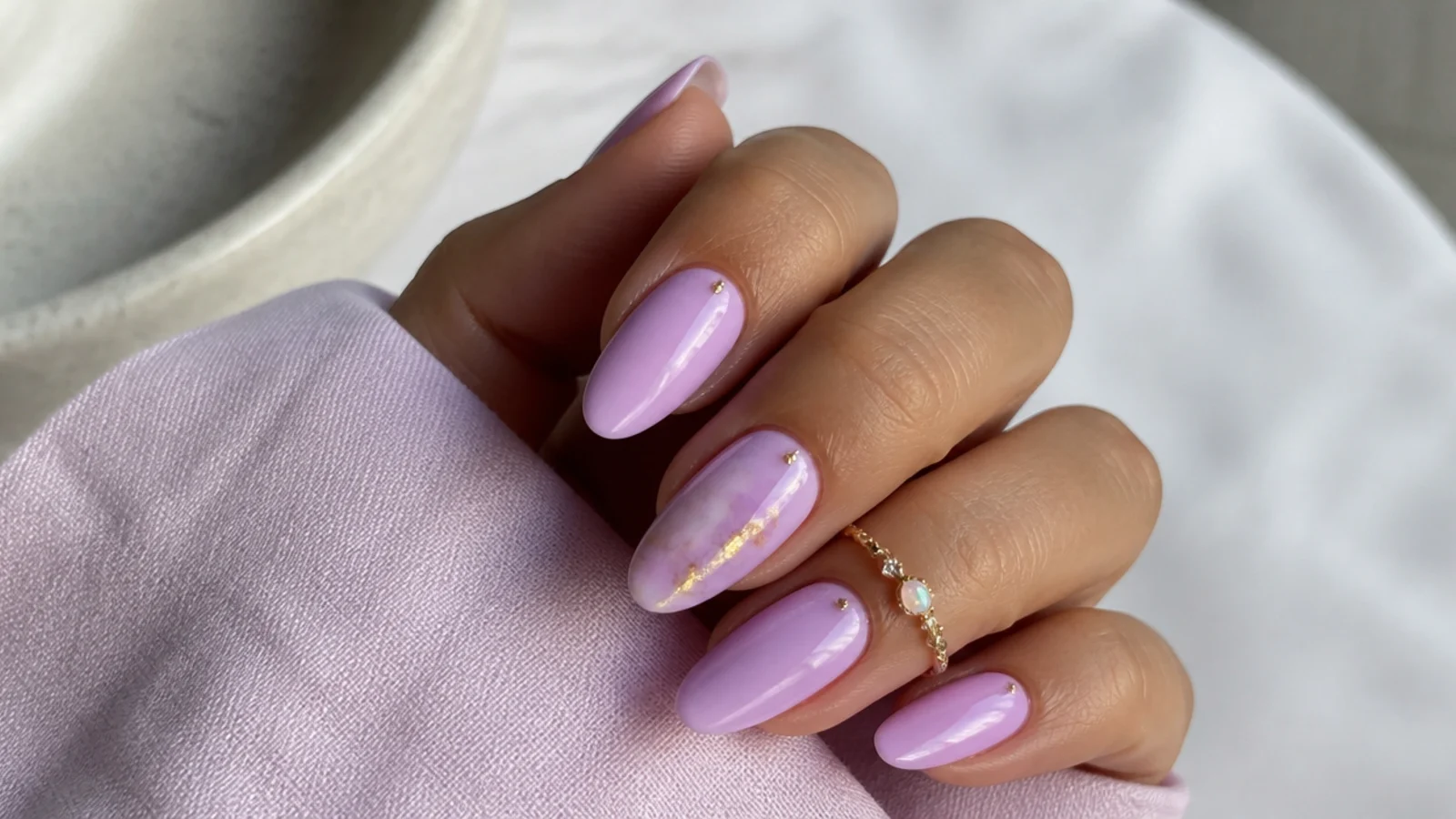 Warm pink-lilac light purple nails on warm, tan hands