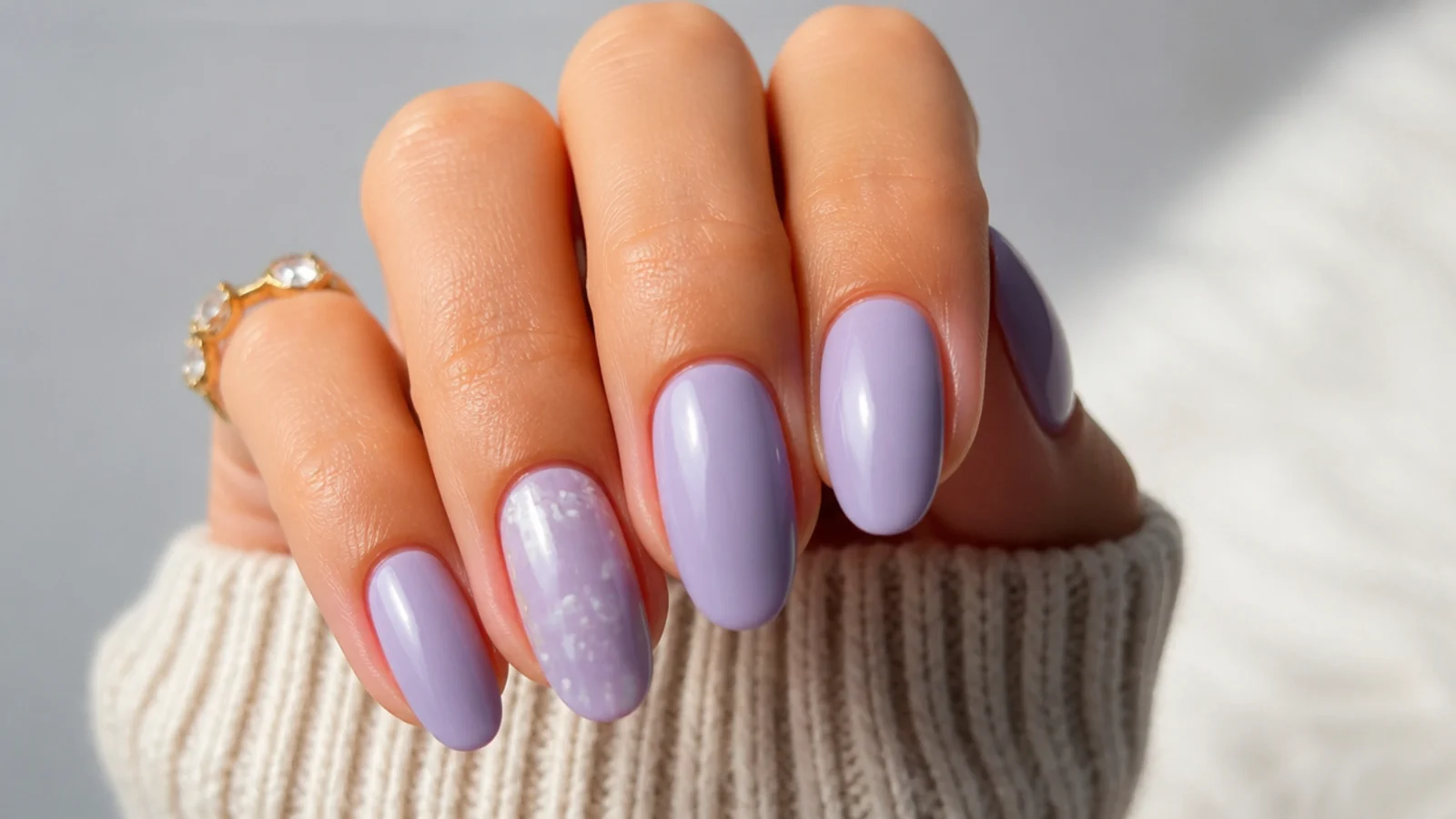 Muted grayed lilac light purple nails on a medium skin tone