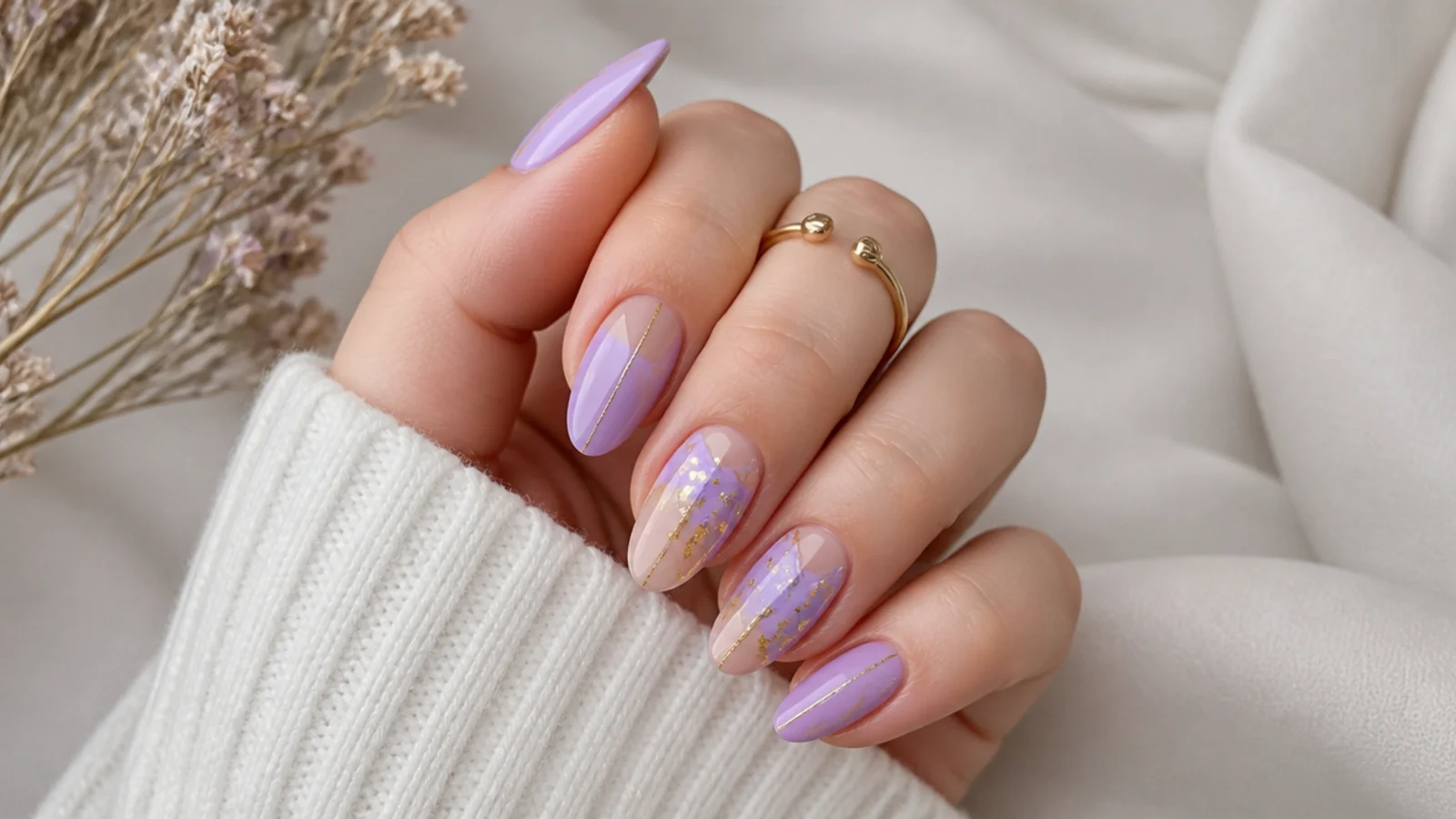 Light purple nails with delicate gold foil and fine line accents
