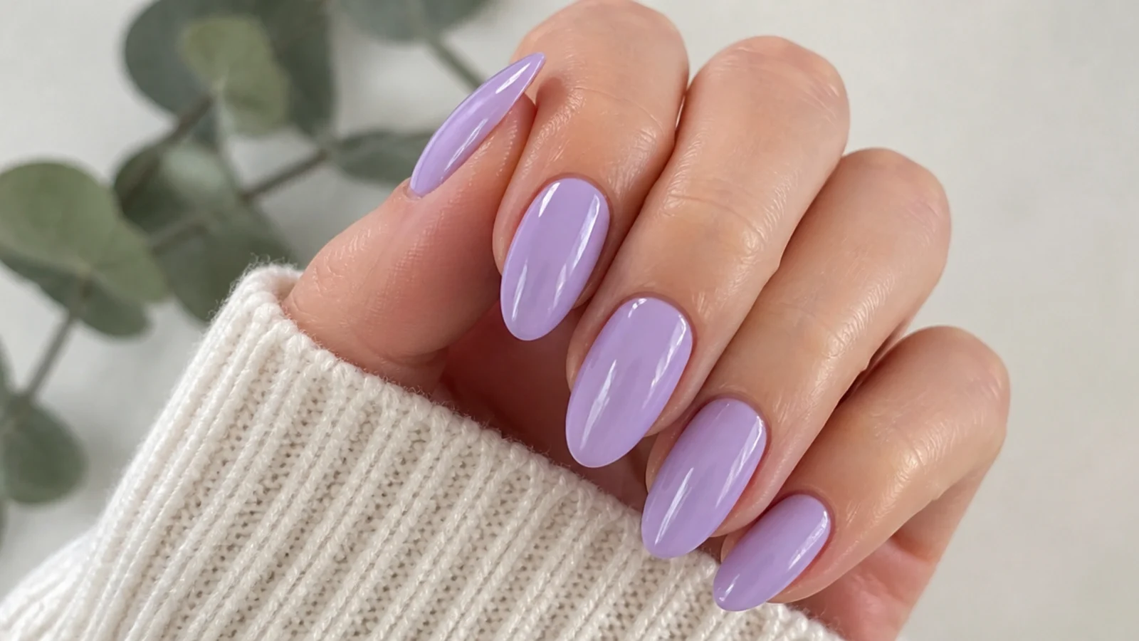 Soft lilac light purple nails on a medium-length almond shape