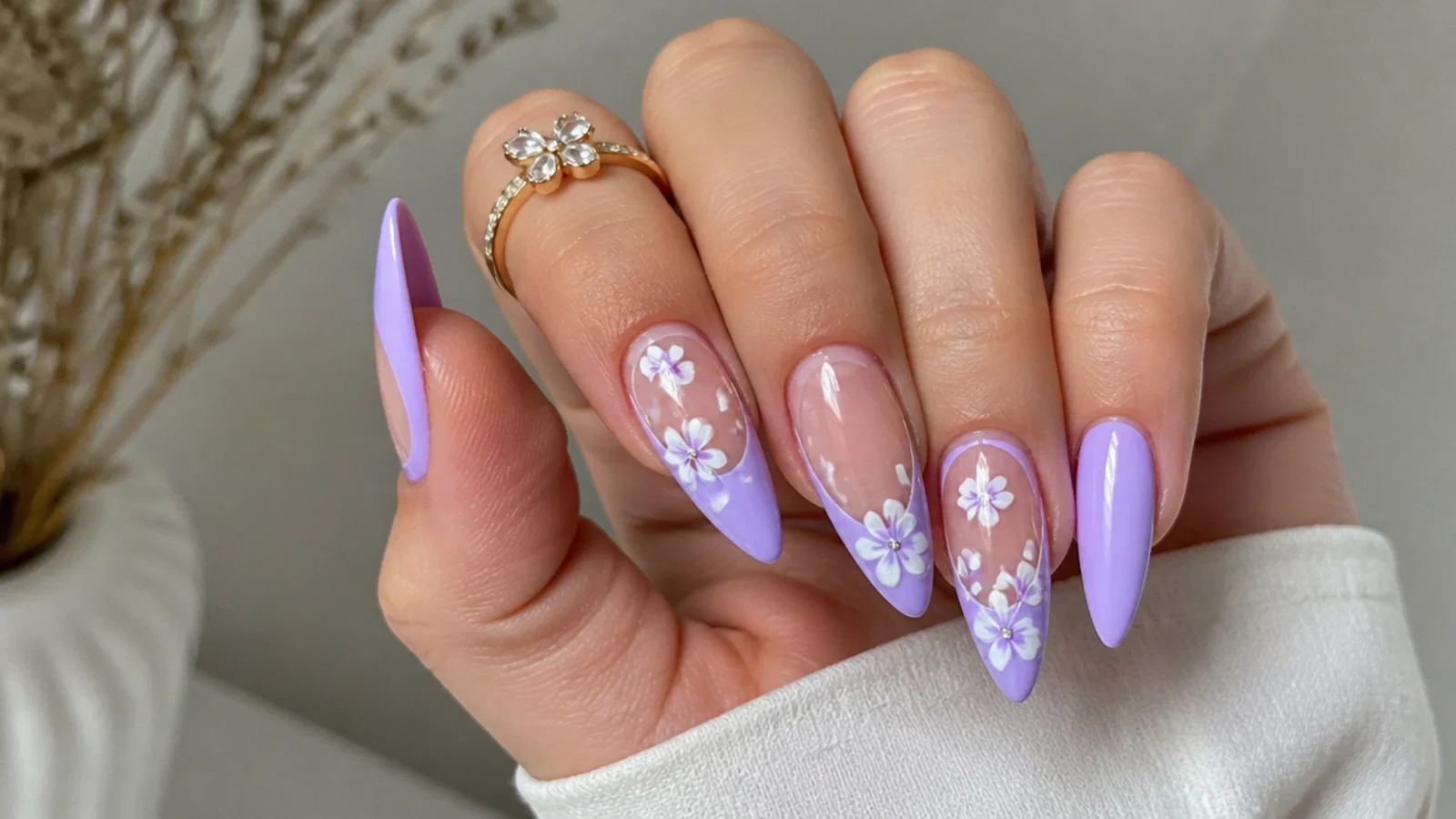 Long pointed light purple nails on a sharp stiletto shape