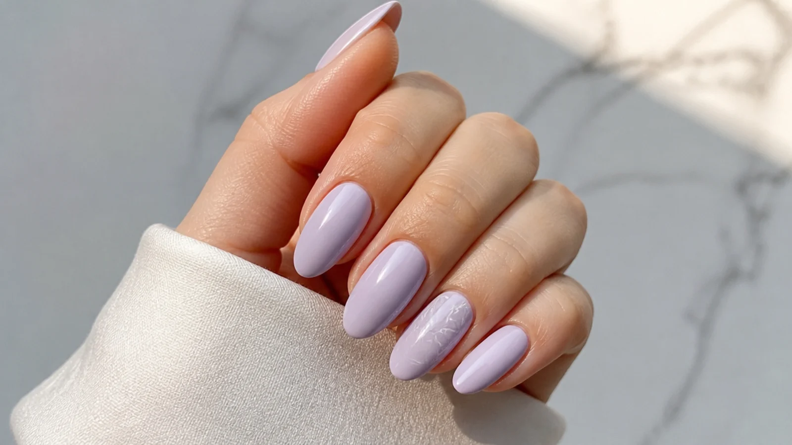 Soft milky lilac light purple nails on an almond shape