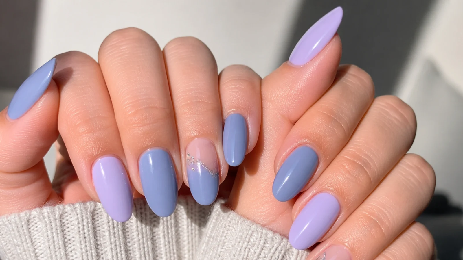 Side by side light purple lilac and true gray-blue lavender nail swatches