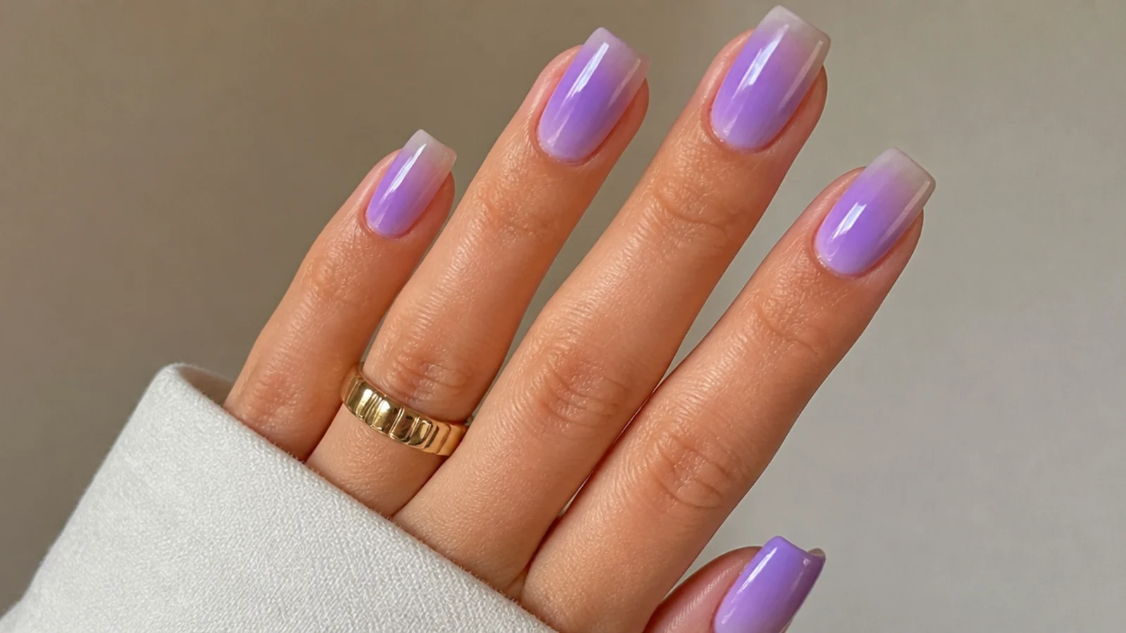 Cool blue-based lilac ombre nails fading to clear on a squoval shape