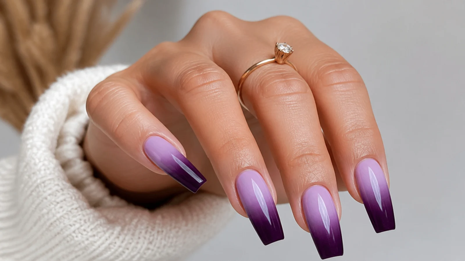 Deep purple fading up into pale lilac ombre nails on a coffin shape