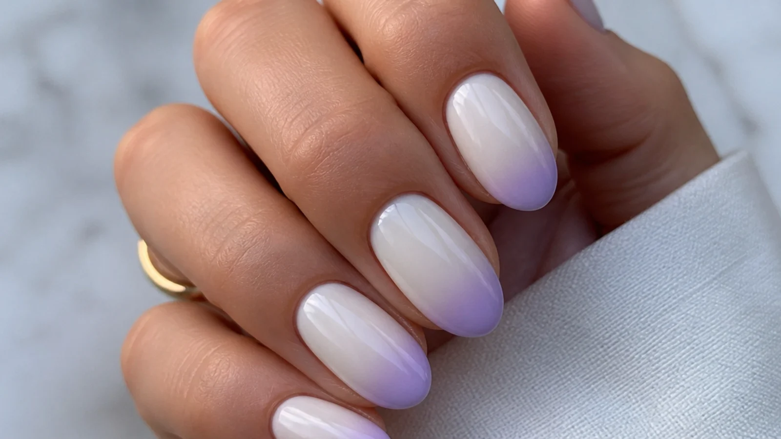 Milky white nails with soft lilac ombre tips on a short almond shape