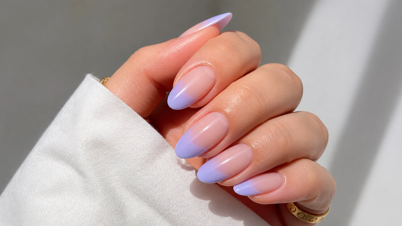 Nude to lilac French ombre nails with a soft white smile line on almond