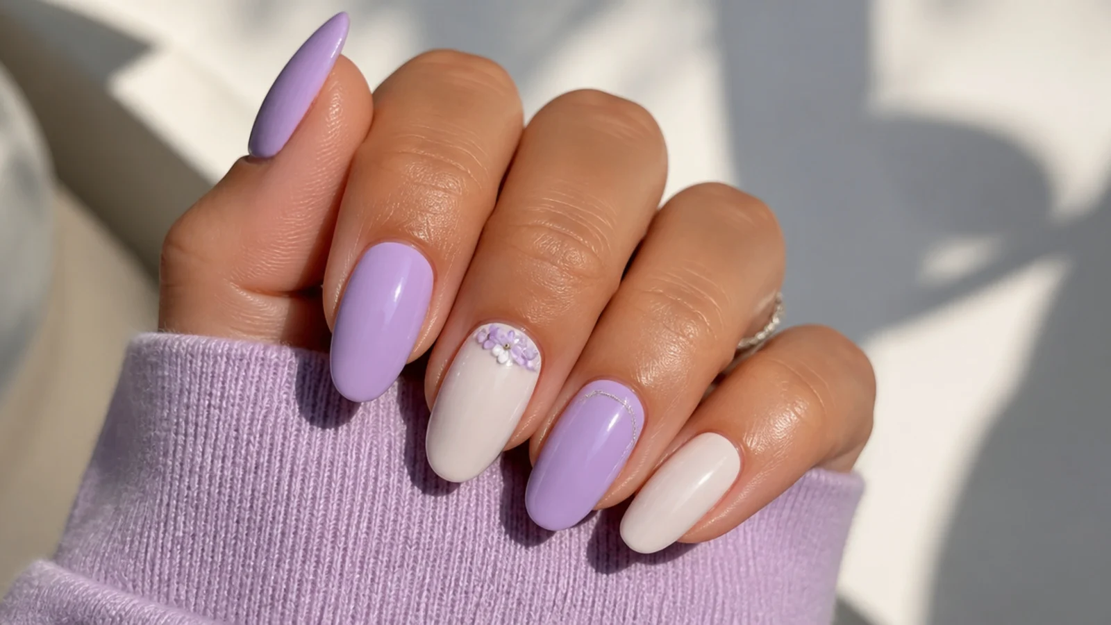 Alternating soft lilac and creamy white pastel prom nails
