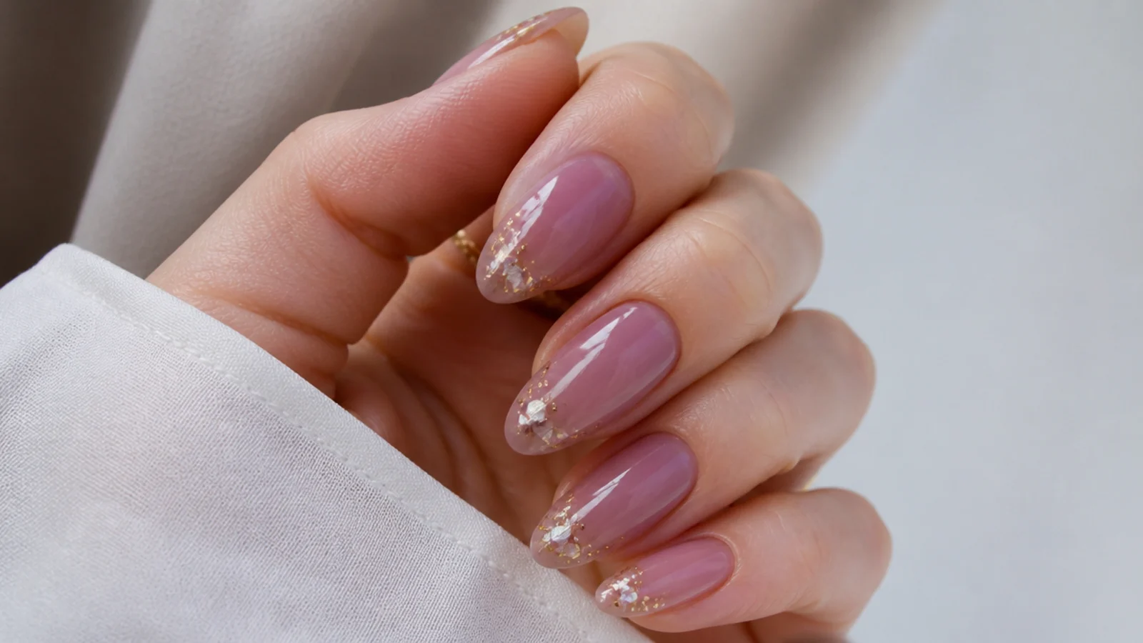 Warm pink-lilac prom nails with a soft glossy glow on almond nails