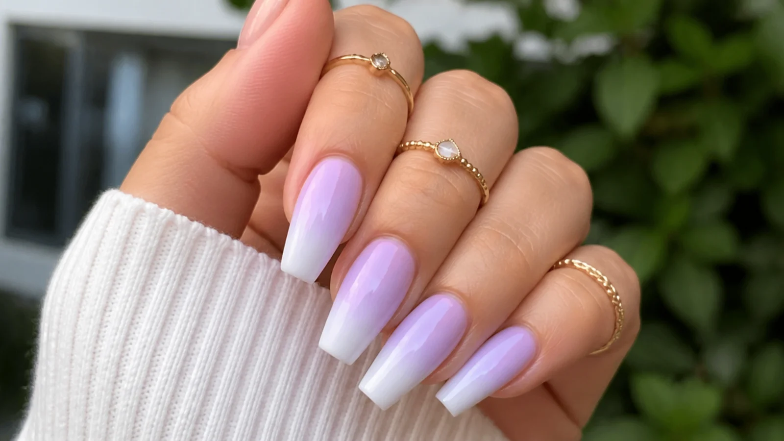 Light purple ombre nails fading from lilac to white on coffin nails