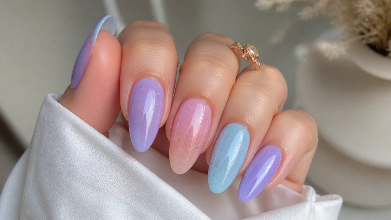 Alternating pastel light purple, soft pink and light blue prom nails