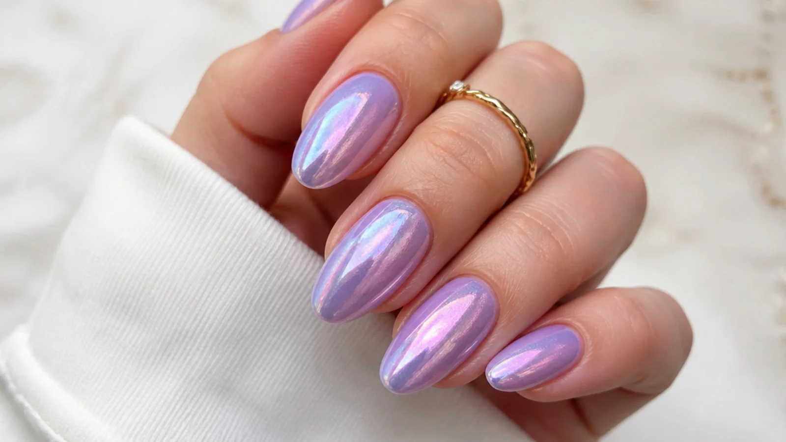 Light purple nails with an iridescent aurora shimmer shifting pink and blue