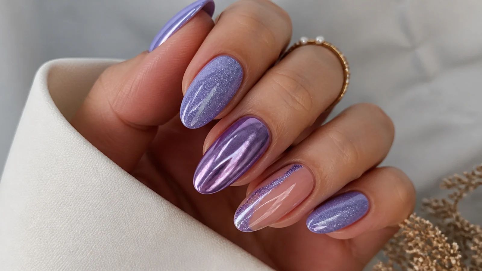 Soft glam light purple prom nails on an almond shape with chrome and glitter accents