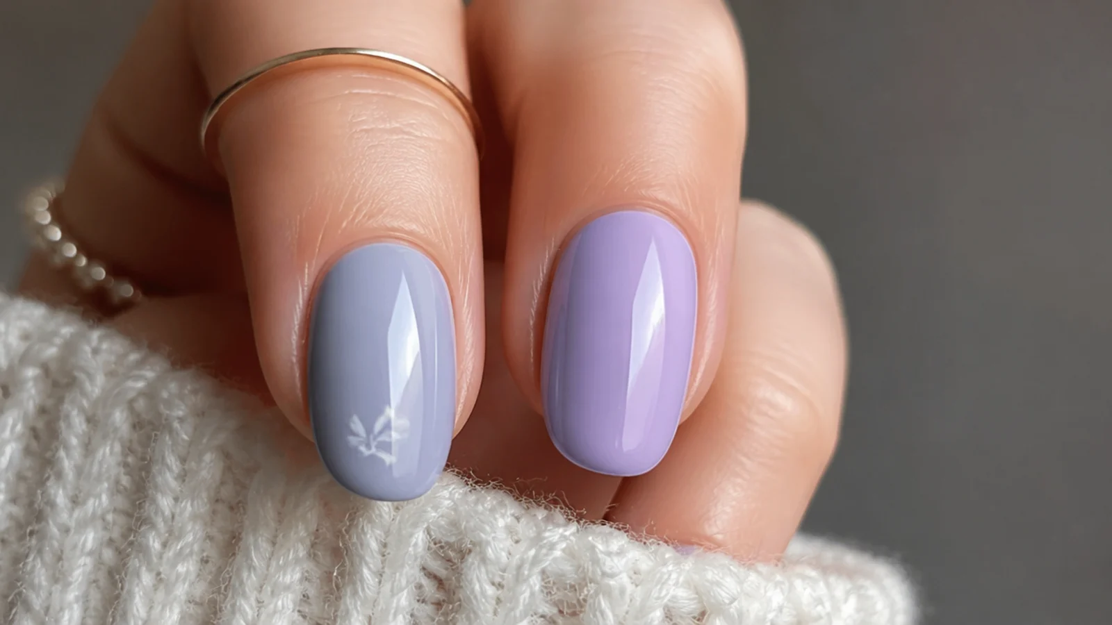 A soft gray-blue lavender nail beside a broader lilac light purple nail