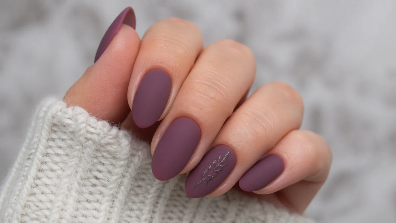 Muted matte dusty plum nails on an almond shape