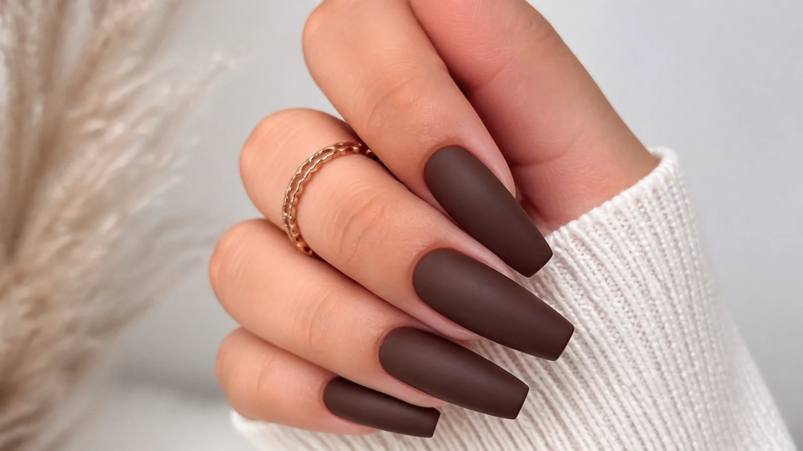 Deep matte chocolate brown nails on a coffin shape