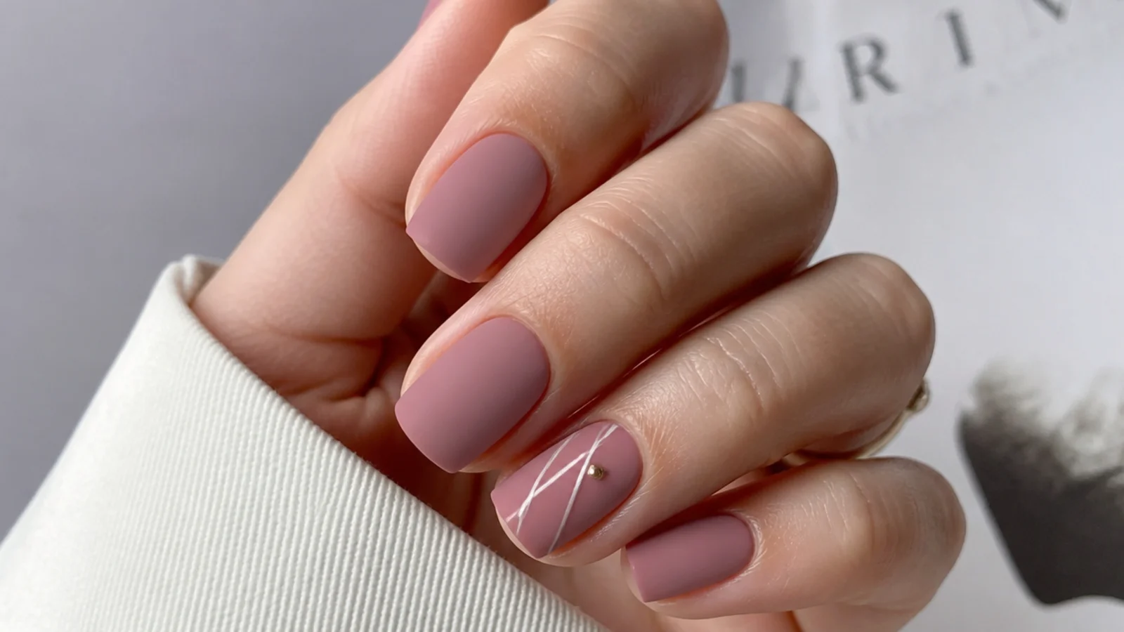 Soft matte dusty rose mauve nails on a short squoval shape