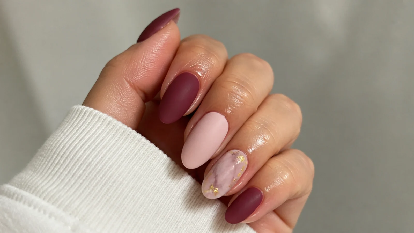 A well-sealed matte gel manicure with cuticle oil applied around the nails
