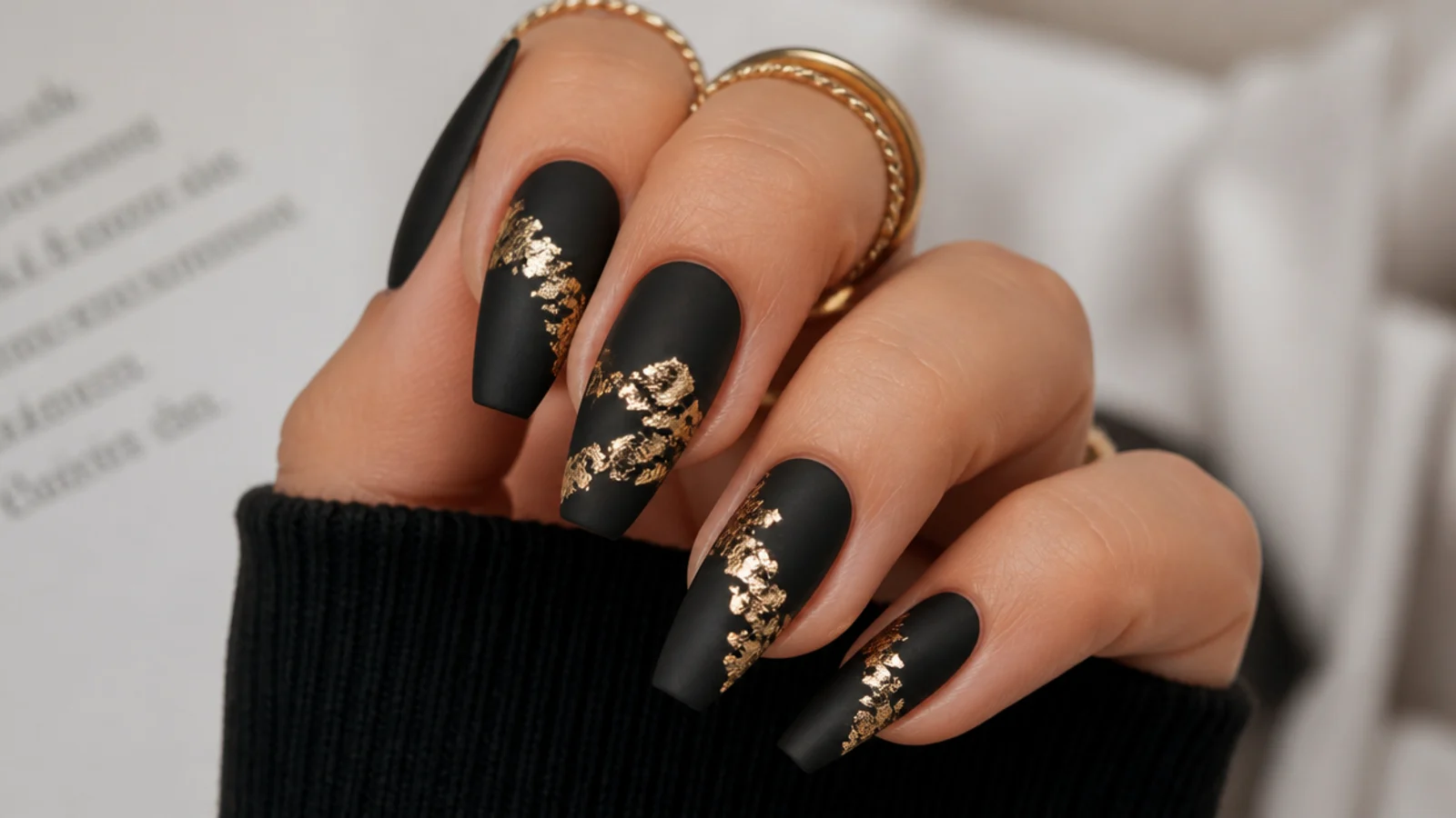 Matte black nails with cracked gold foil accents