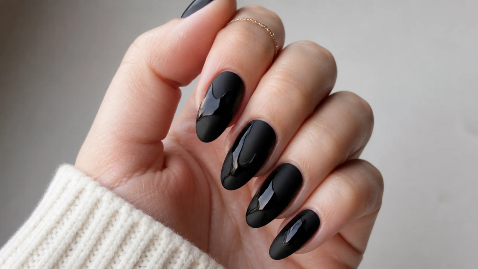 Matte black nails with glossy black abstract shapes and lines