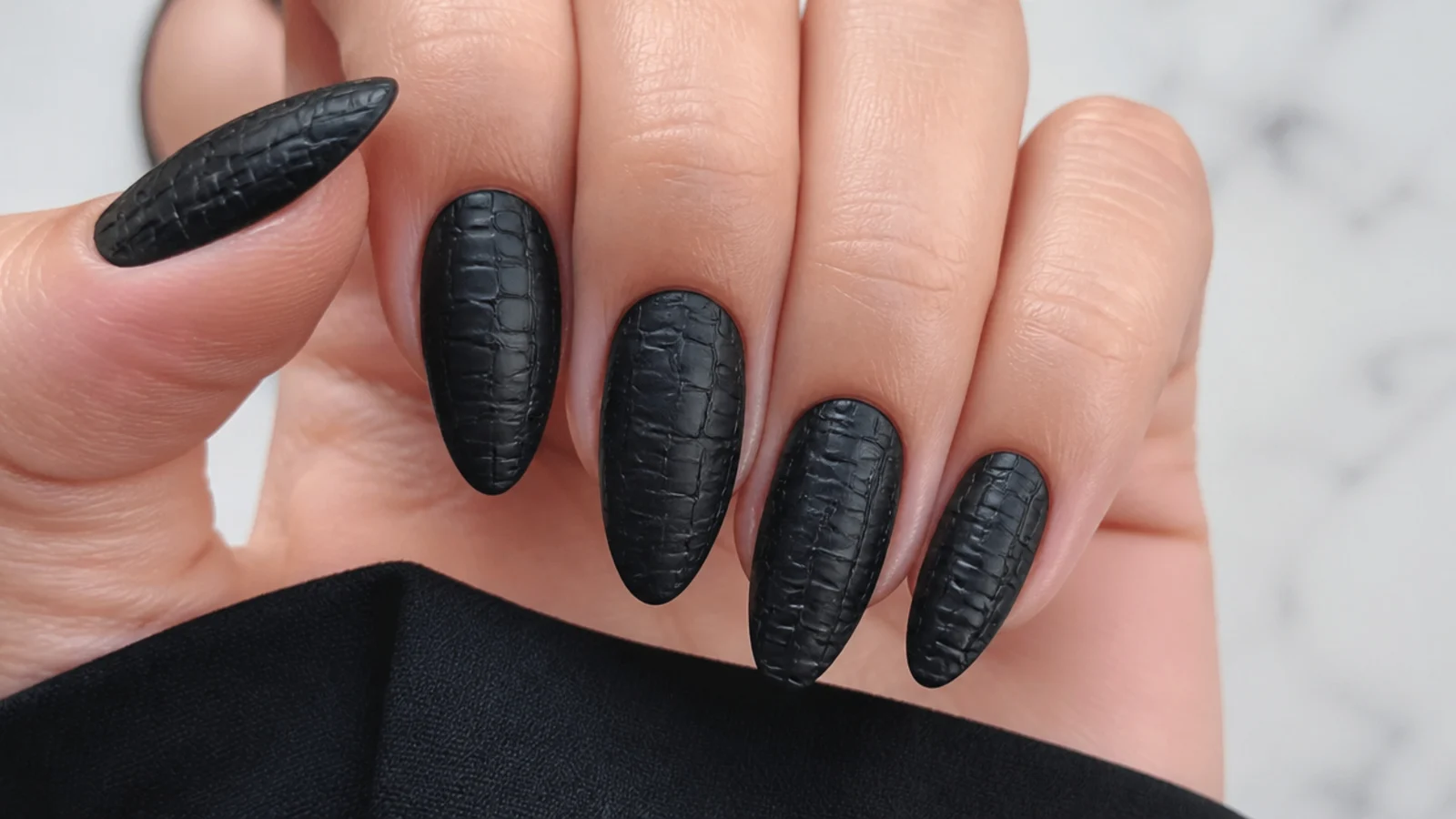 Matte black nails with a raised crocodile skin texture