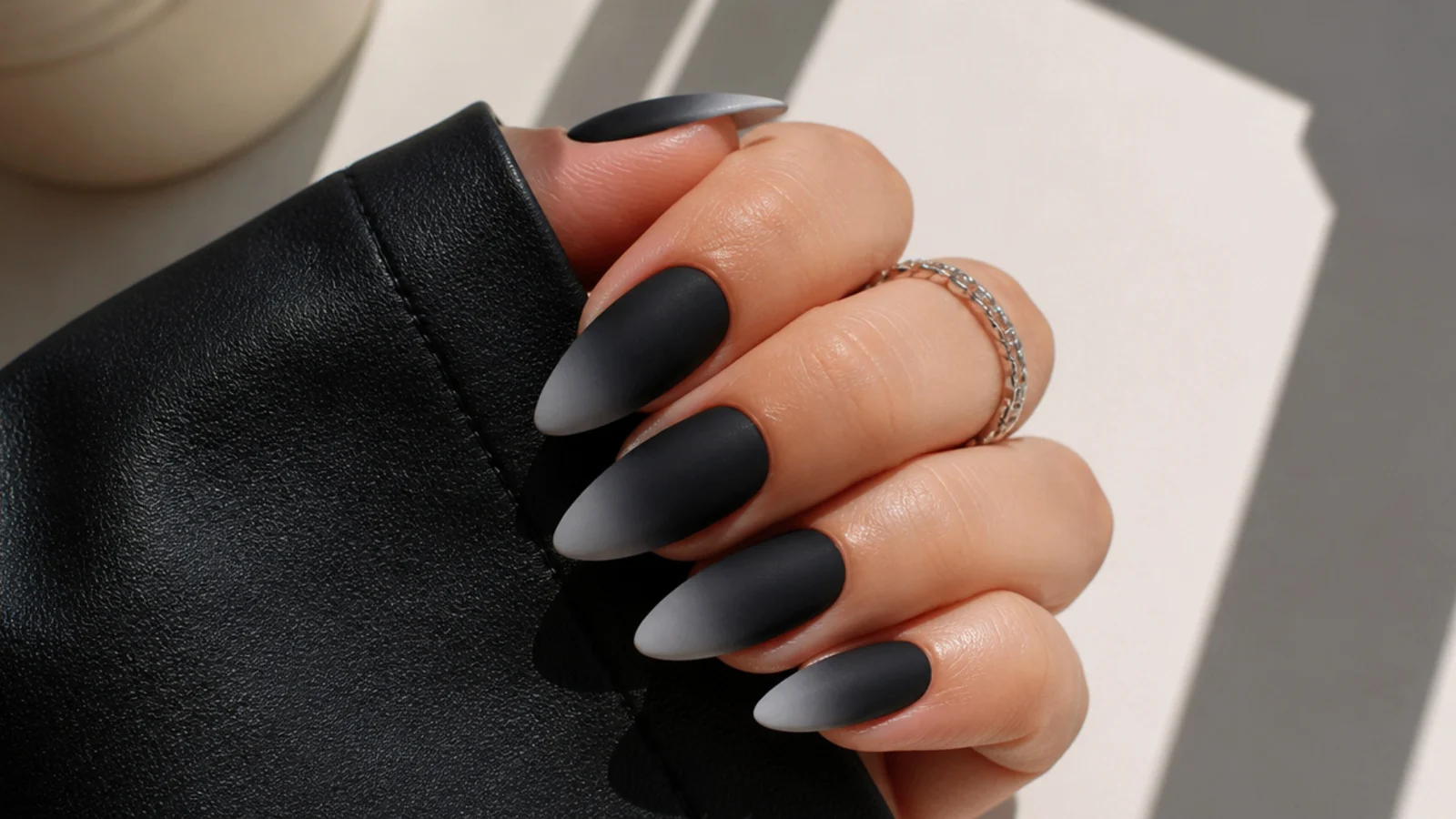 Matte black to gray ombre nails fading at the tips