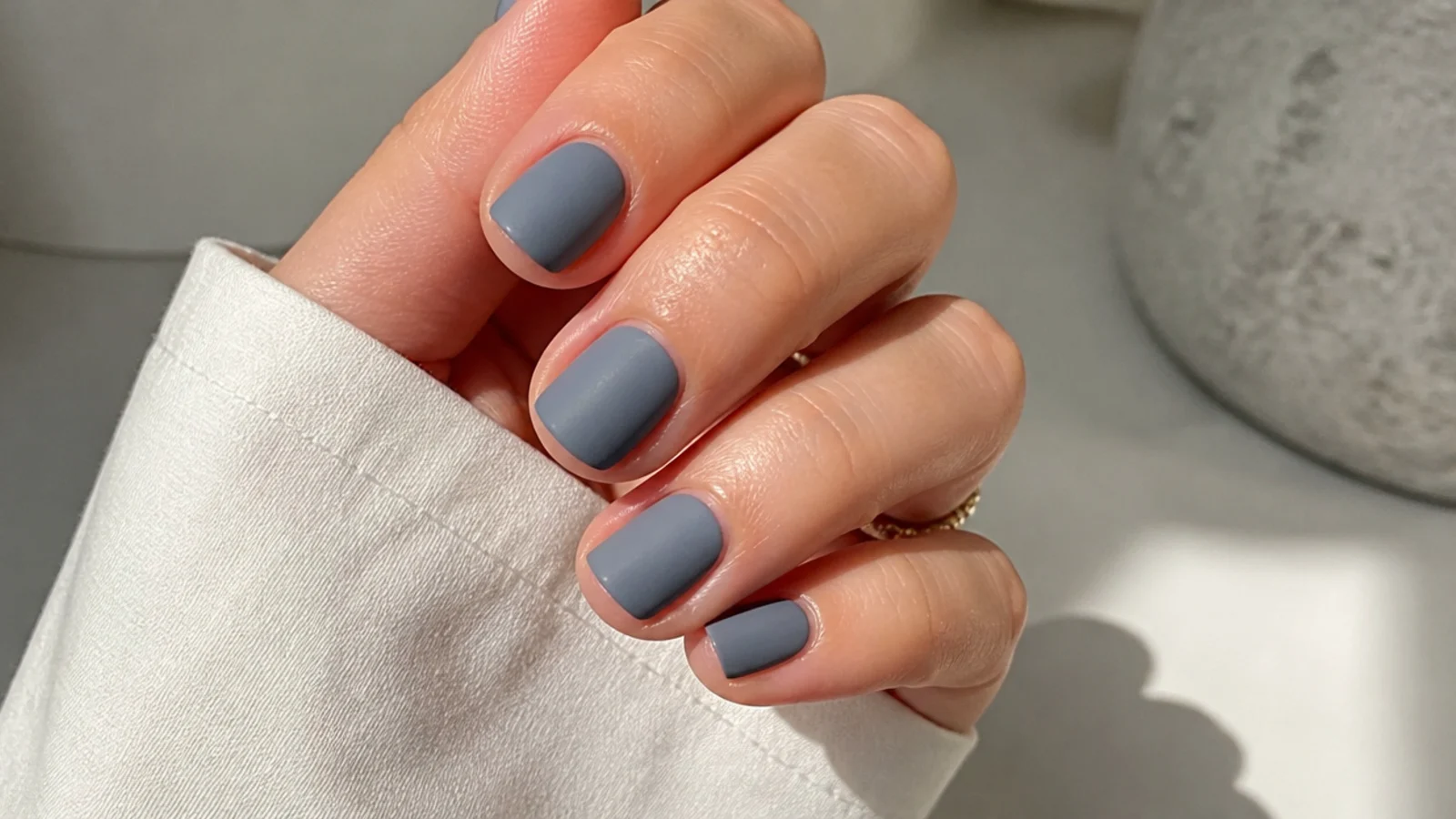 Muted matte gray-blue nails on short round tips