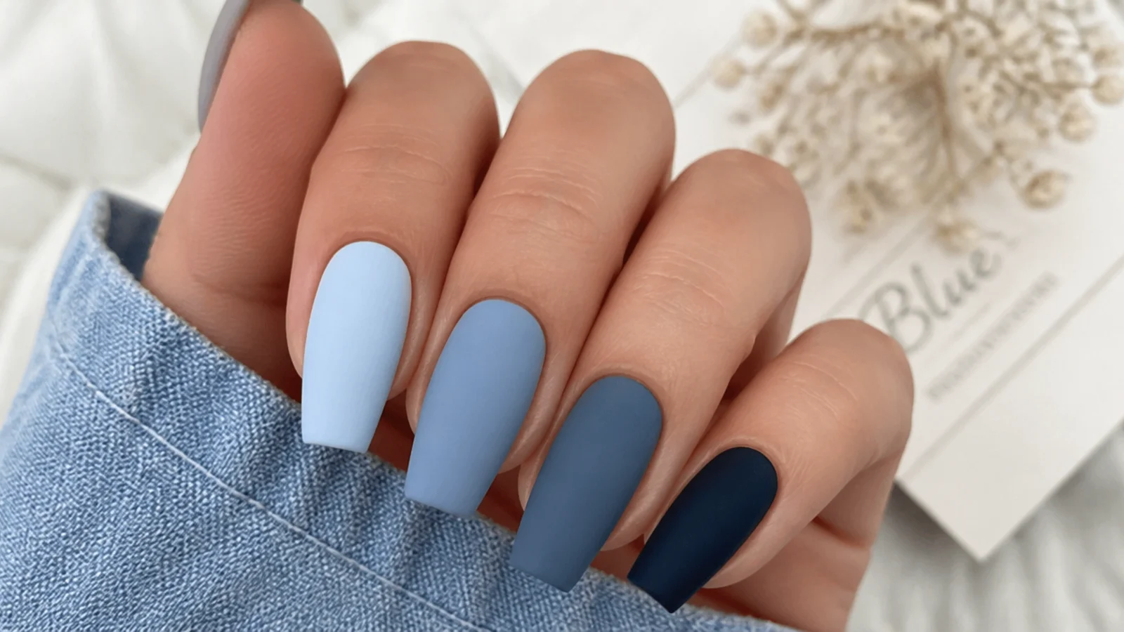 Four matte blue swatches from icy pale to deep navy for seasonal use