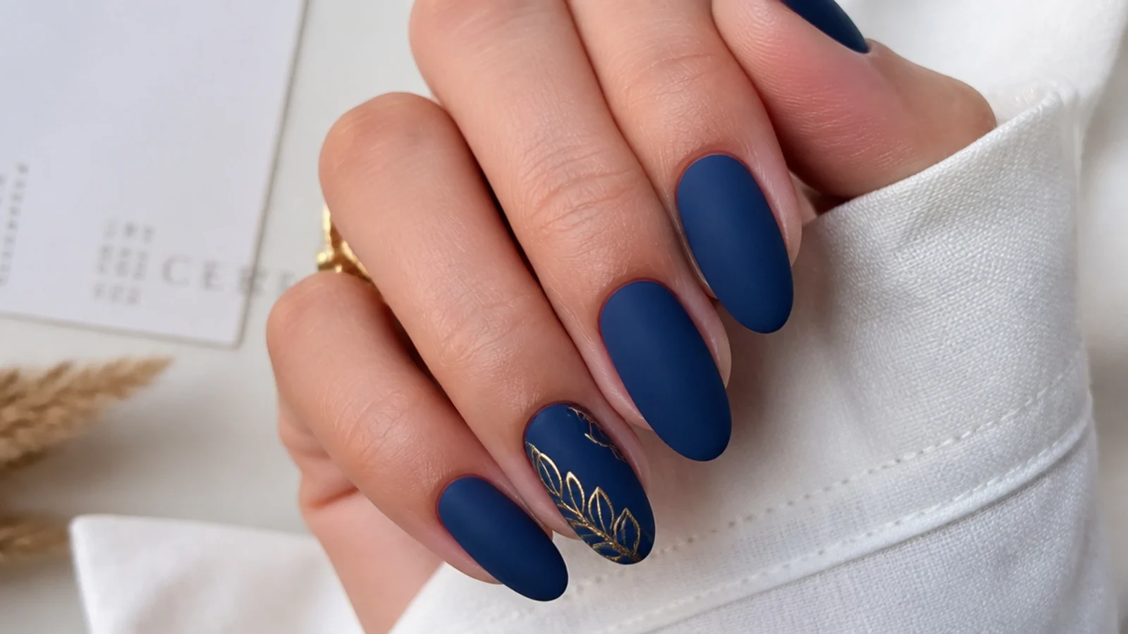 Soft velvety matte navy blue nails on an almond shape